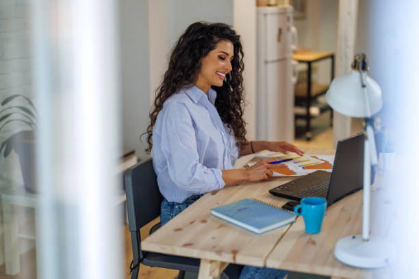 istock Young woman working on laptop in home office 1391986224