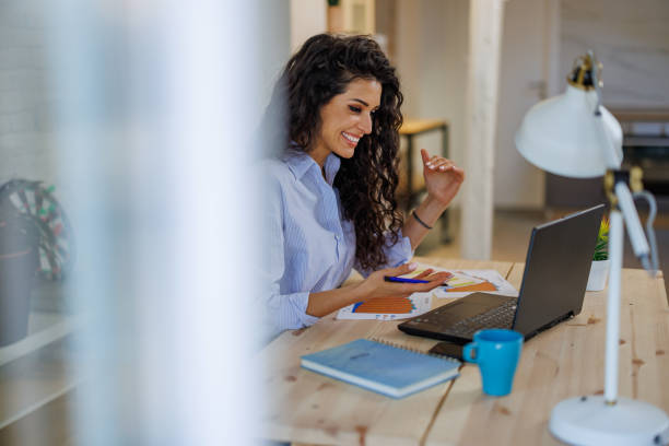 istock Young woman working on laptop in home office 1391986233