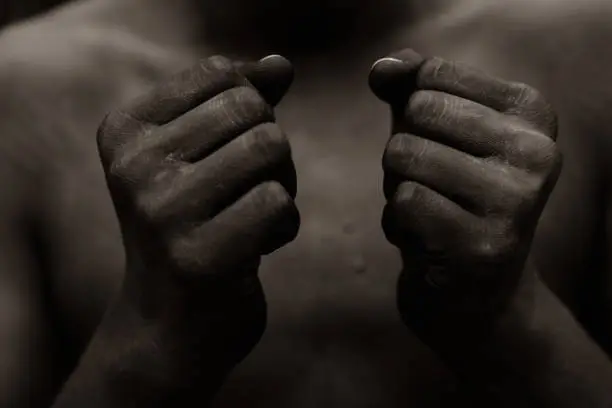 Photo of Black person holding fist in front of chest