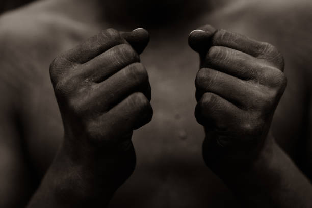 black person holding fist in front of chest - slave labor imagens e fotografias de stock