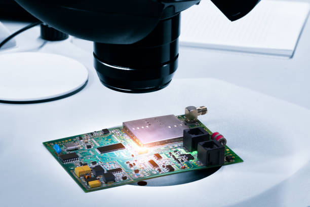 istock Chip testing equipment. Manufacturing of microchips. A close-up study of a test sample of a transistor chip under a microscope in the laboratory. Automation of production. 1391988868