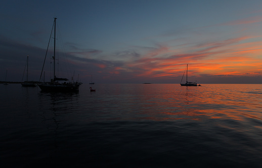 Anchored sailboats at sunset, Unije island, Adriatic Sea, Croatia