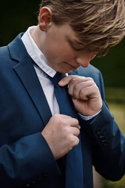 istock Teenager dressed for his communion 1391991281