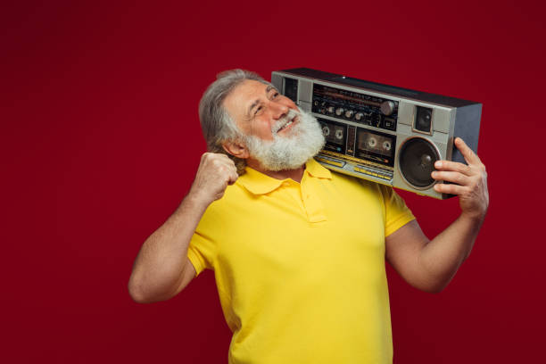 istock Old man holding with cassette boom box enjoying music 1391993300