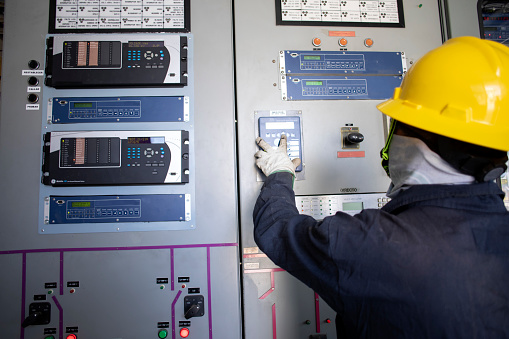 electrical workers in substation, wotking