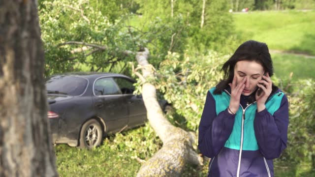 portrait of a girl with a phone, the consequences of a natural disaster