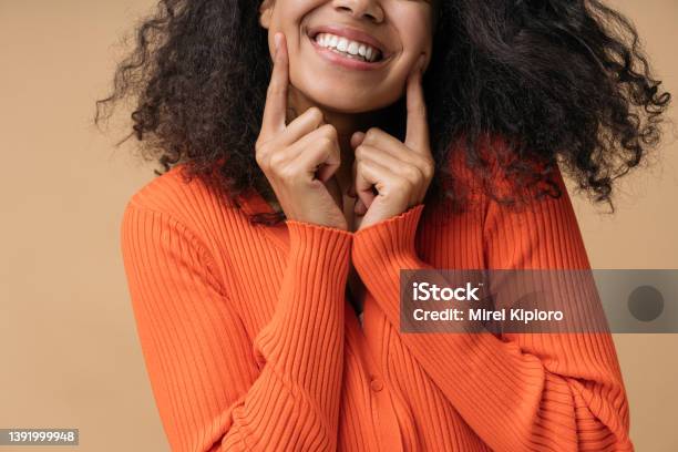 Happy African American Woman Pointing Finger On White Teeth Isolated On Background Health Care Dental Treatment Concept Stock Photo - Download Image Now