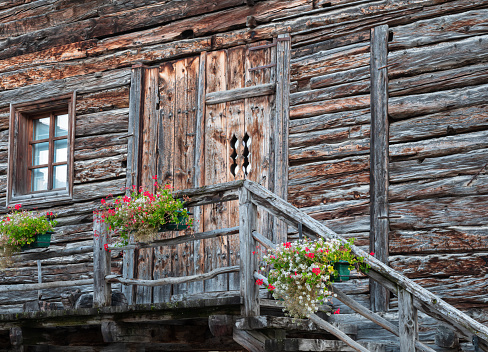 Facade of old wooden vintage house in alpine village of Livigno, Italy