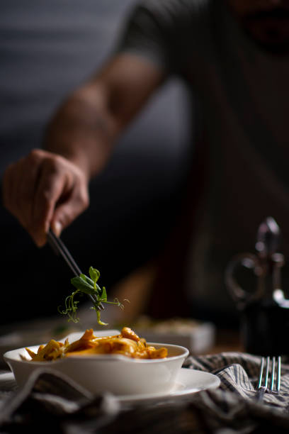 Closeup of male chef in restaurant decorates the meal stock photo