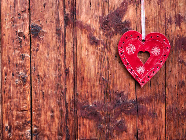 La Punt, Switzerland - September 29, 2021: Decorative red heart hung on a wooden wall