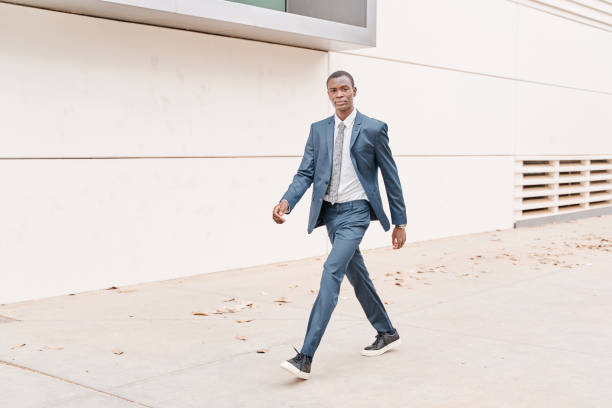istock african american businessman walking looking at camera 1392018442