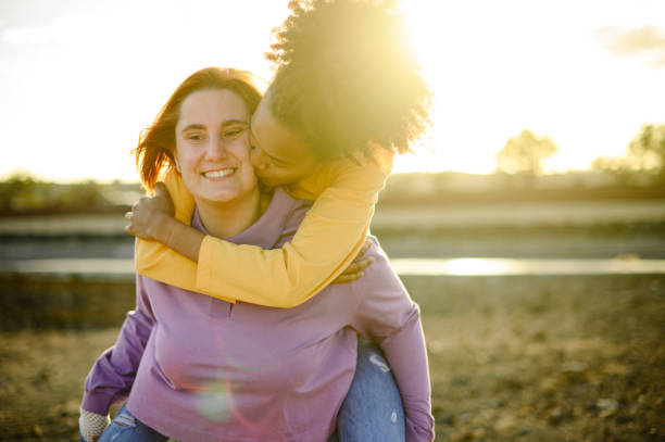 istock Happy lesbian couple hugging in park 1392019068
