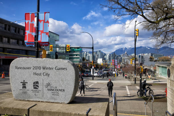 April 9, 2022  Vancouver 2010 Winter Games Host City monument near Vancouver City Hall at sunny day with view of Cambie street and background of downtown cityscape and mountains, Vancouver, Canada