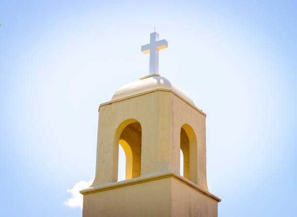 istock Light behind a church bell tower 1392022975