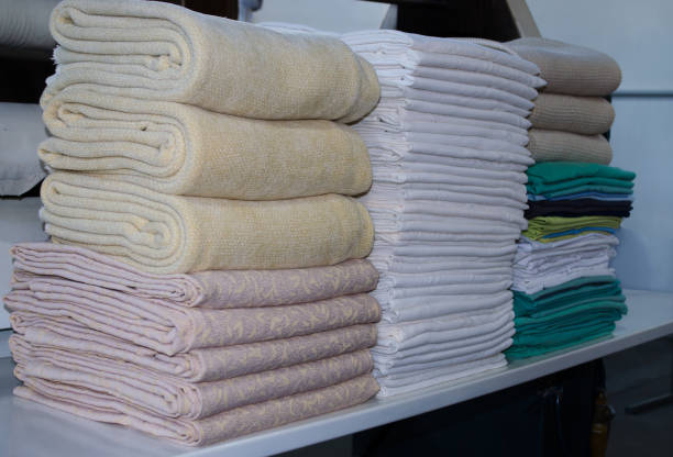 istock Stack of folded clean sheets and surgical clothes in an industrial laundry. 1392029871