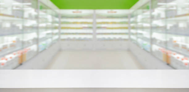 Empty white counter with pharmacy drugstore shelves blurred background