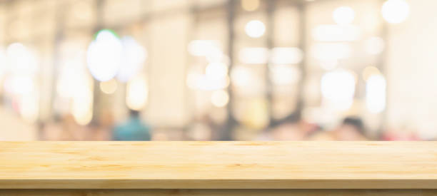 istock Empty wood table top with cafe restaurant interior blurred background 1392030674