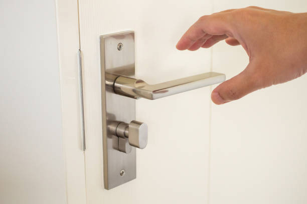 istock Man hand holding door handle close up 1392030686