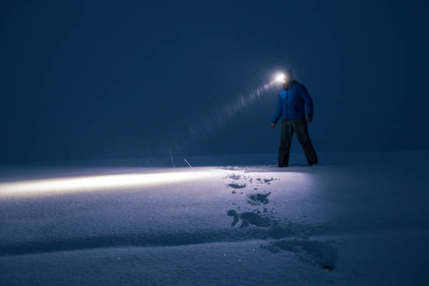 istock Man in deep snow at night searching for the road. 1392030717