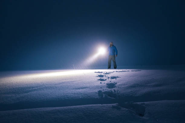 istock Man in deep snow at night searching for the road. 1392030719