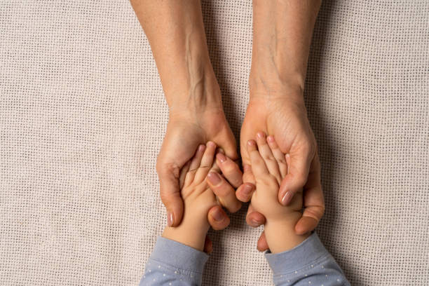 istock Grandma's hands are holding baby's hands.Lay lat. 1392031451