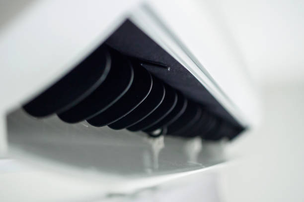 istock Air conditioner on white wall room interior background 1392031453