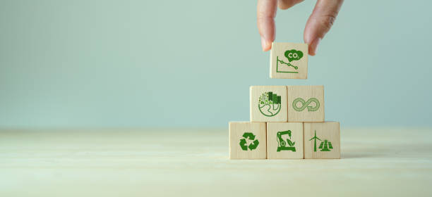 istock Low carbon,carbon neutral concept. Net zero greenhouse gas emissions target. Climate neutral long term strategy. Hand put wooden cubes with decrease carbon emission icon and green icon. Green banner. 1392032355