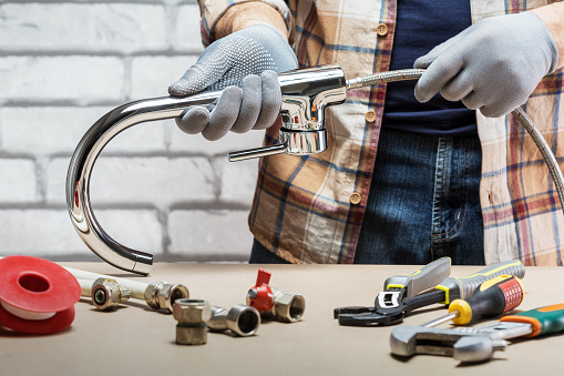 Man plumber at work, plumbing repair service, assemble and install concept.