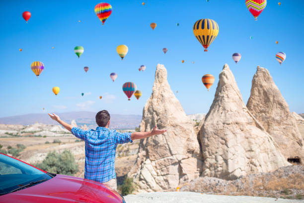 istock Happy man on summer vacation in famous place. Cave formations. 1392033183