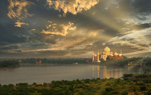 The Taj Mahal, the ivory-white marble mausoleum on the right bank of the river Yamuna just before sunset in the Indian city of Agra.
