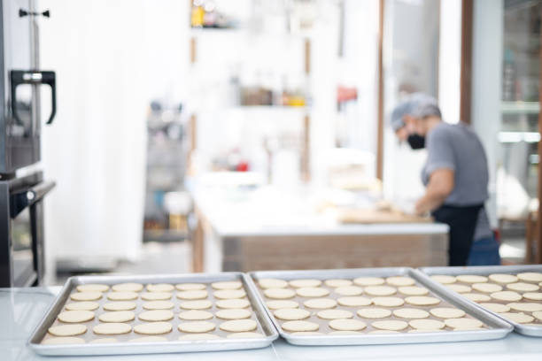 istock Selective focus and blurred background of beautiful bright and white decorative bakery kitchen with people or chef is working to prepare dough for making fresh dessert and bread for lunch or dinner. 1392038512