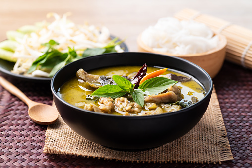 Thai food, Green curry chicken eating with rice noodles and fresh vegetables