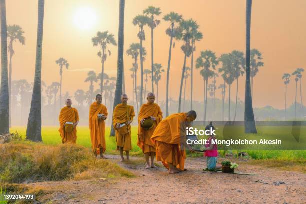 Thai Girl From Village In Rural Of Thailand Offering Foods To Buddhist Monks Stock Photo - Download Image Now