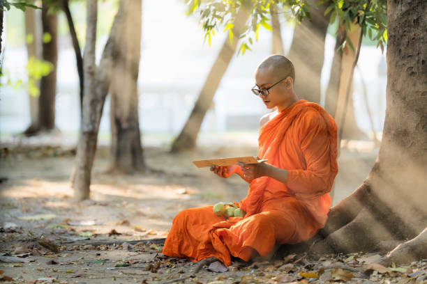 istock Buddhist monk in buddhism school monastery reading Buddhist lessen book 1392044281