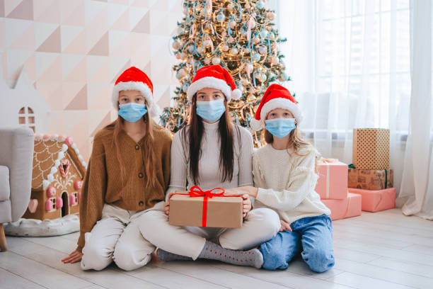 istock Young mom with kids holding christmas presents 1392045691