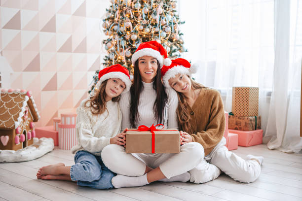 istock Young mom with kids holding christmas presents 1392045700
