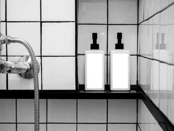 istock White blank labels mockup on two shower bottles, pump bottle with dispenser for liquid soap, shampoo, shower gel, side view. Close-up empty package label on containers on grid tiles wall in bathroom. 1392046939