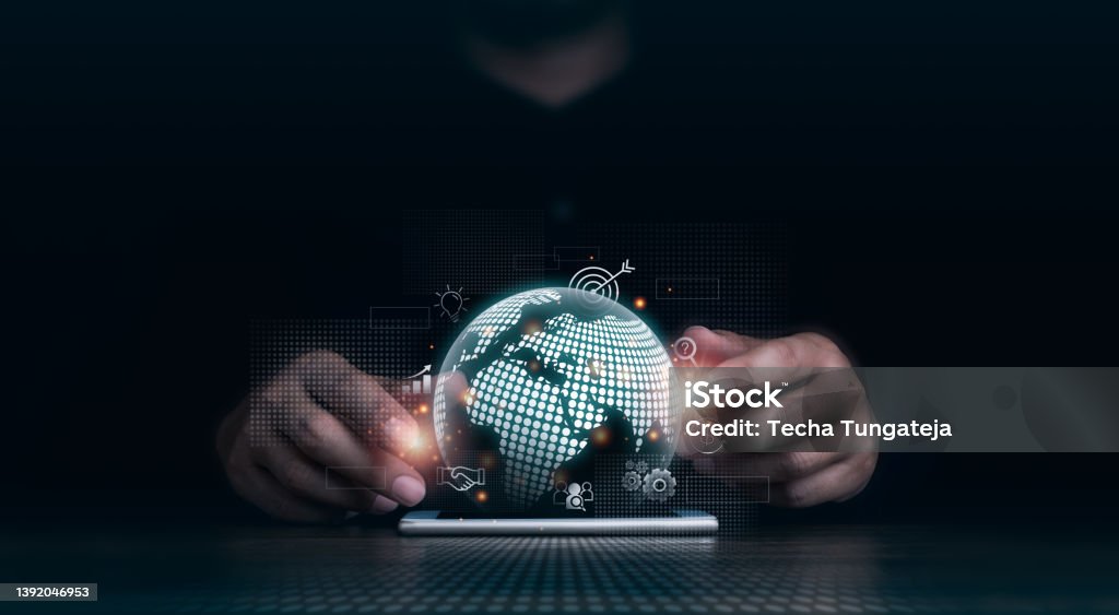 Investment technology with a global internet connection, financial, banking application, and big data network concepts. Hand using mobile smart phone with virtual digital earth and business icons. Technology Stock Photo