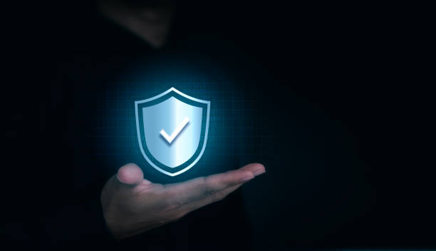 istock A virtual shield lock icon with the correct sign appeared on the human's hand on dark background with copy space. Cyber security, data protection, business privacy technology concept. 1392047075