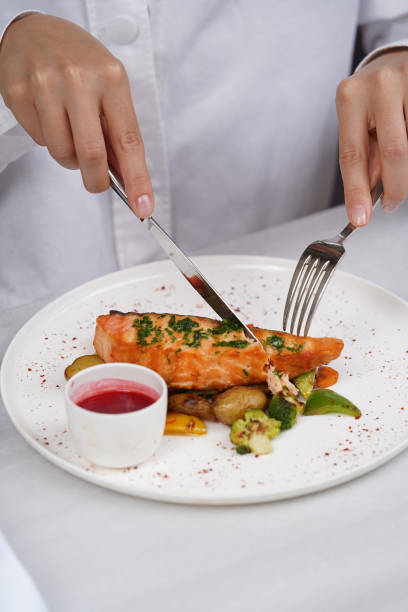istock Grilled salmon and baked vegetable on a white plate 1392047092