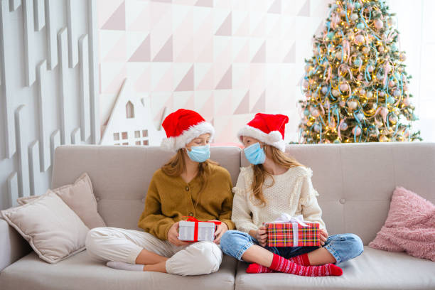 istock Happy kids holding christmas presents 1392047739