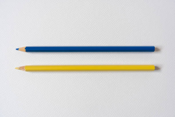 blue and yellow colored pencils on paper - mathematical symbol mathematics pencil sharp imagens e fotografias de stock