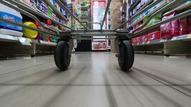 Shopping cart through supermarket time lapse shot