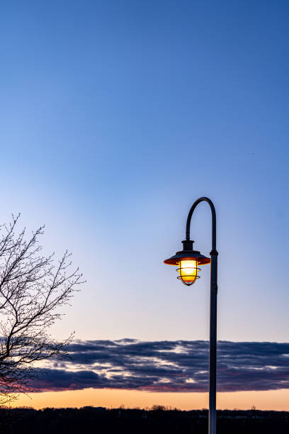 istock Beautiful yellow street light with cloudy sunset and mountains 1392052855