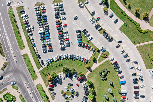 aerial top view of parking lot with many parked cars from above