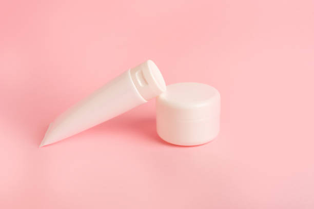 istock two clean plastic boxes with body cream on a pink background 1392060677