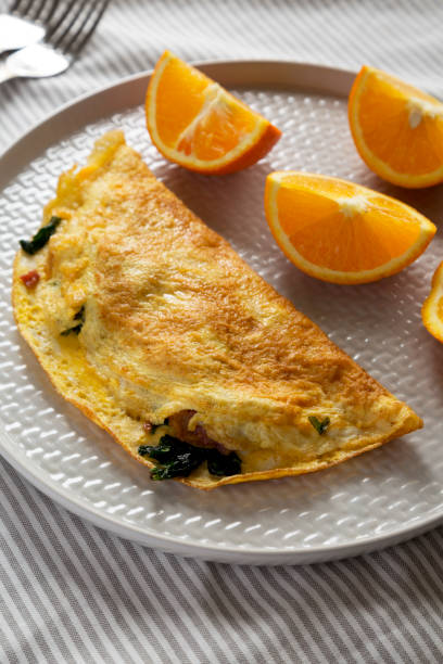istock Homemade Bacon Spinach Omelette with Cheddar, side view. 1392069658