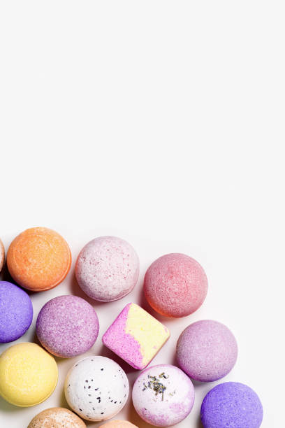 istock Pattern with colorful bath bombs on white paper background. Bathing balls with essential oil for relaxation and aromatherapy. Body care natural products. Colored cosmetic bomb for spa 1392069698