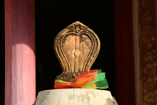 Closeup of Bai Sema or Sacred Boundary Stone in front of the Old Ordination Hall of Wat Chomphuwek Buddhist Temple in Nonthaburi Province, Thailand