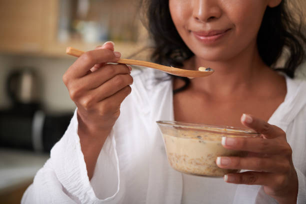 istock Woman Eating Granola with Berries 1392072776
